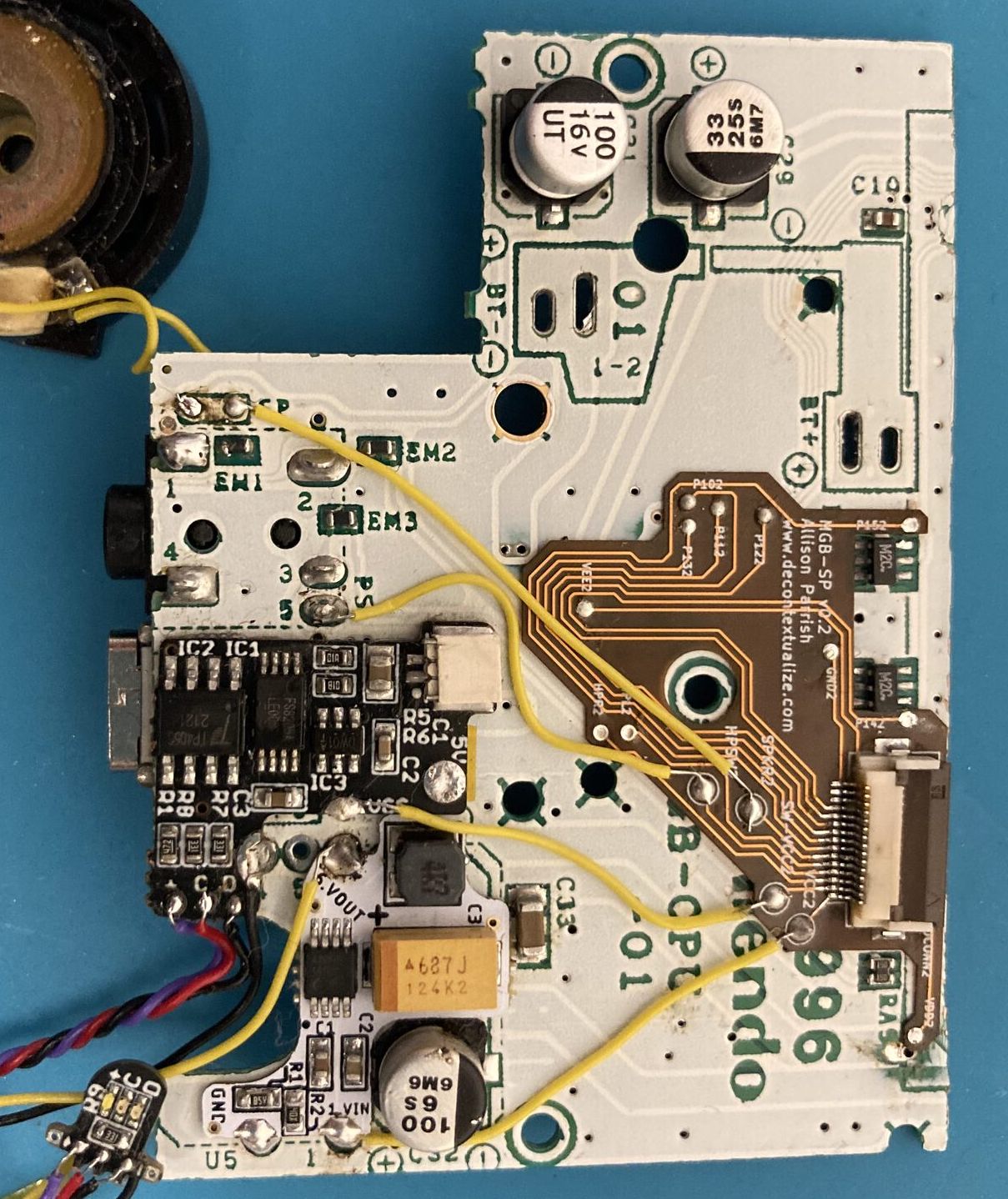 Lower half of flex PCB soldered to lower half of Pocket motherboard