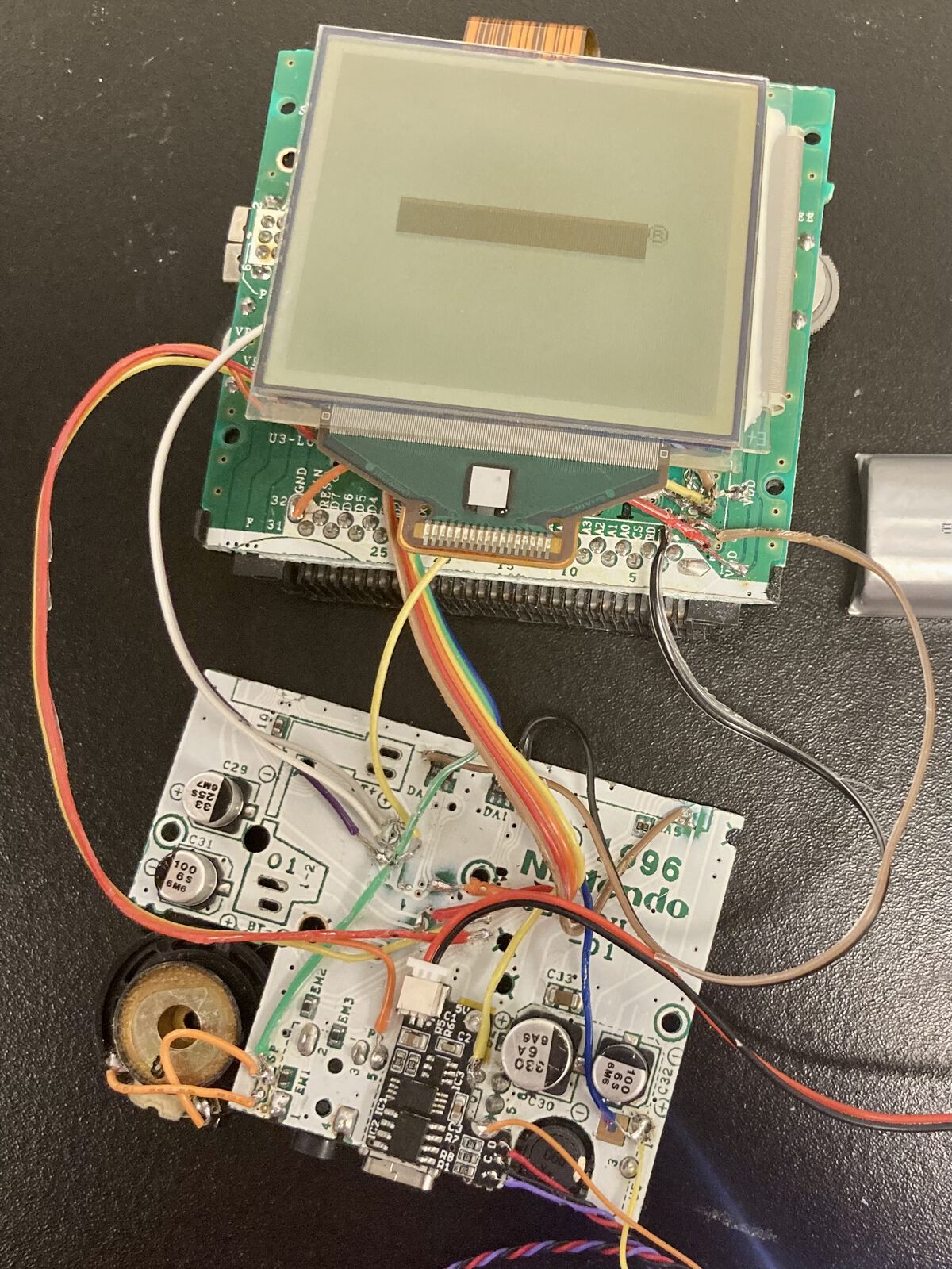 Two halves of the Pocket board with a bunch of wires connecting them. It’s kind of gruesome, but the Game Boy boots.